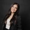 Picture of Anahi smiling in front of a black background